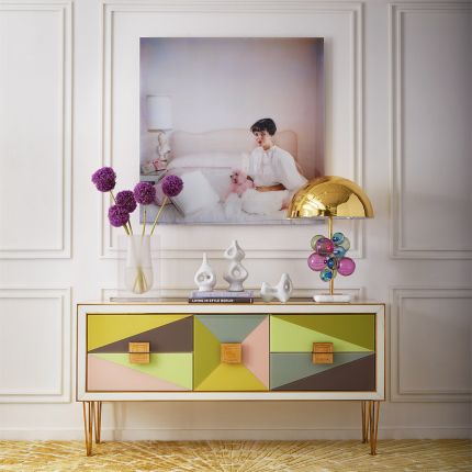 A glamorous multicoloured sideboard with painted glass and brass accents
