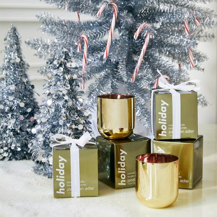 A glamorous, gold metallic candle by Jonathan Adler with a lovely winter scent 