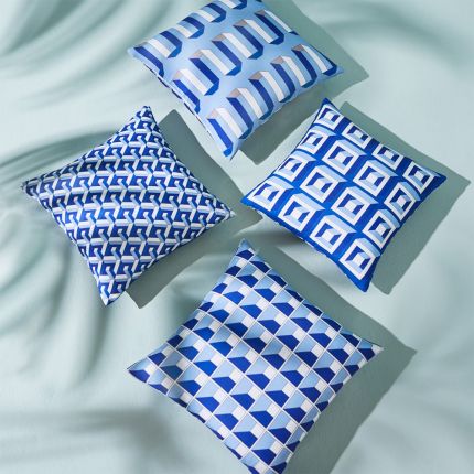 A bold and beautiful blue cushion by Jonathan Adler with a graphic and reversible design