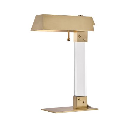 A timelessly elegant aged brass and acrylic table lamp