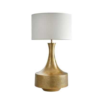 An elegant antique brass engraved table lamp with an off-white shade
