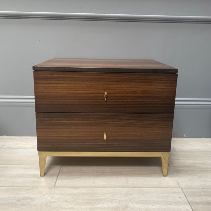 Light brown bedside table with two drawers and brass details