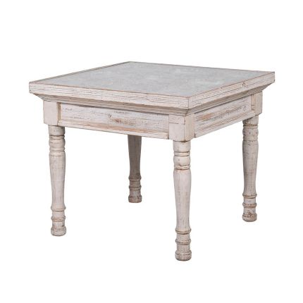washed wood side table with intricate carved detailing