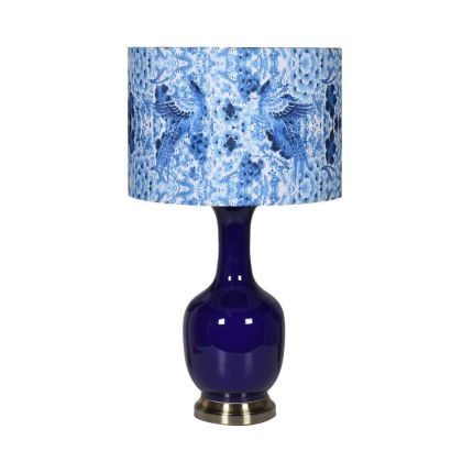 Shiny blue table lamp with blue patterned lamp shade on brass base