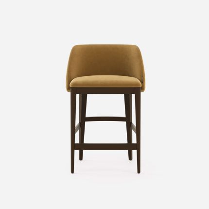 A sophisticated modern counter stool with suede upholstery and wooden legs 