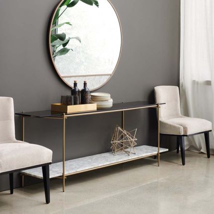 A luxurious contemporary metal and marble console table with a tinted glass top