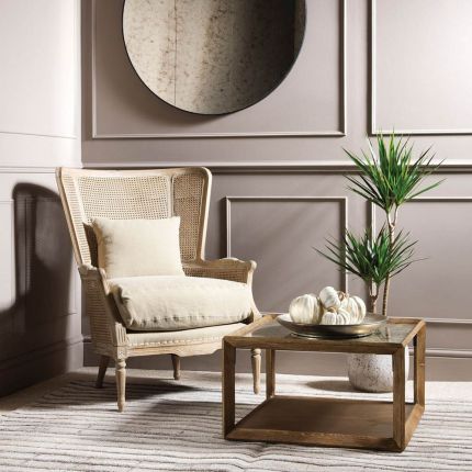 Elegant rattan armchair with linen seat cushion and scatter cushion