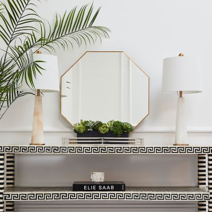 The perfect finishing touch for any interior style, this minimal, eight-sided wall mirror boasts a gorgeous antiqued gold finish that will add a touch of timeless elegance to your home. 