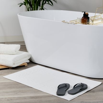 Luxury bath mat with knot embroidered detail
