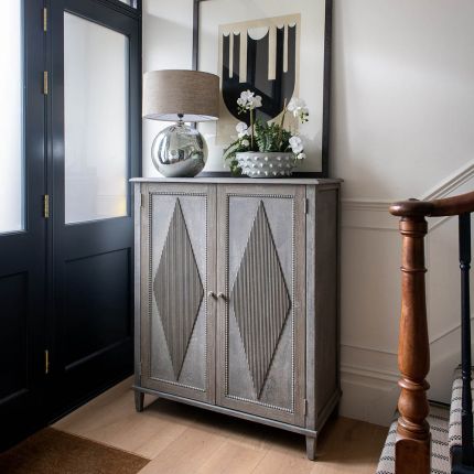 Rustic tall cabinet with ribbed diamond pattern on the doors