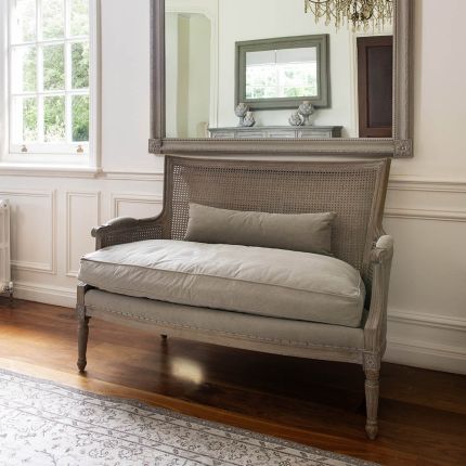 Stunningly charming loveseat with linen seat cushion and rattan backrest