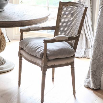 Stunning vintage style chair with rattan backrest, linen chair cushion and arms