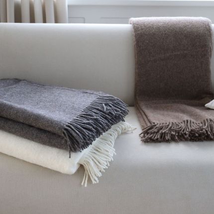 Cosy wool throws in various colour finishes