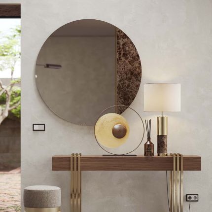 Round, clear mirror with a rosso levanto marble segment and gold finish