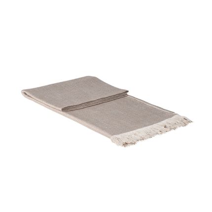 A beautiful oatmeal coloured throw with fringed ends