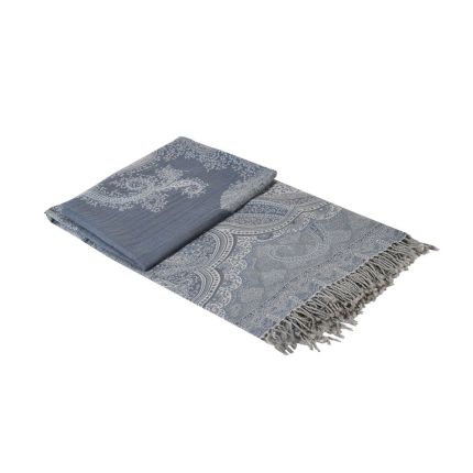 A luxurious blue and grey throw with elaborate, woven detailing and tassels