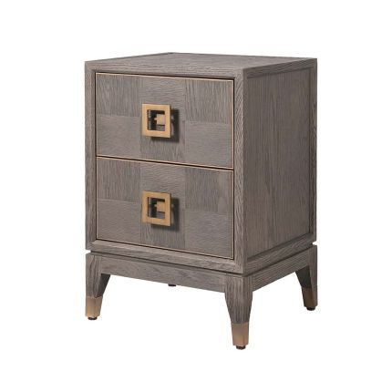 A brown two drawer bedside table with brushed brass hardware and feet