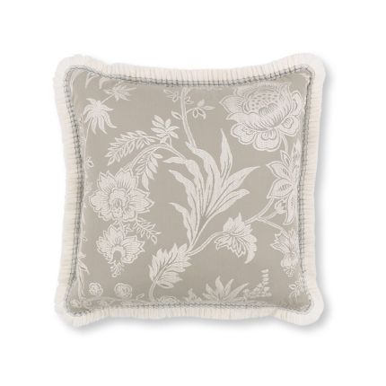 A stunning silver cushion from Romo with a floral design and gorgeous fringed detailing