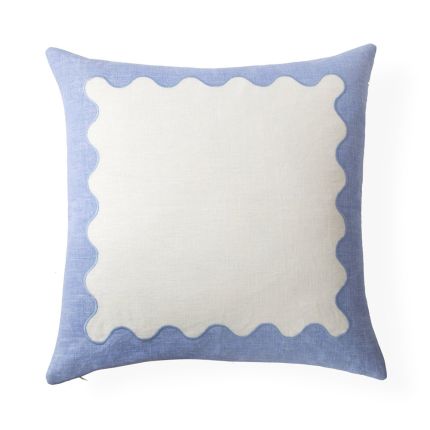 A playful modern blue and white ripple cushion with hand-embroidered details  