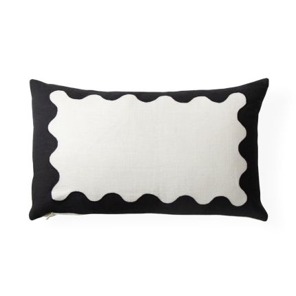 A stylish monochromatic ripple cushion with hand-embroidered details