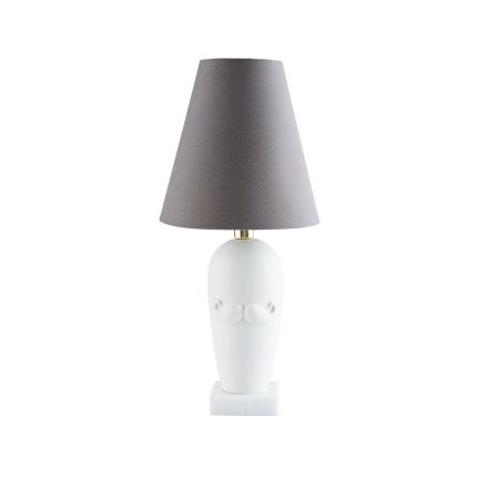 A playful table lamp by Jonathan Adler featuring a porcelain structure with a thick marble base, grey poplin shade, polished brass details and complete with a moustache design
