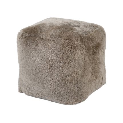 A luxury pouffe with a taupe sheepskin upholstery 