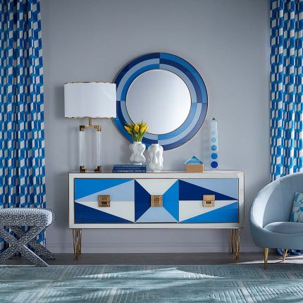 A glamorous contemporary sideboard with painted glass and brass accents