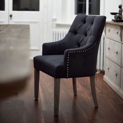 Dining chair with deep buttoning and studs