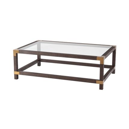 A stylish coffee table by Theodore Alexander with brushed brass corners