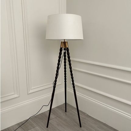 Tripod lamp with black legs and white lampshade 