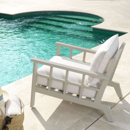 Contemporary greige outdoor armchair with neutral-toned seat cushion by Eichholtz