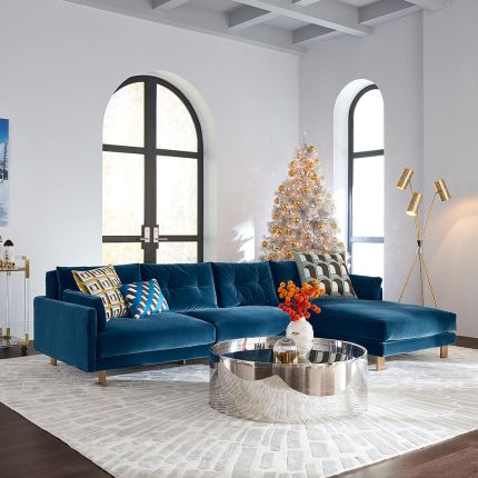 A mesmerising, deep blue corner sofa with brushed brass feet