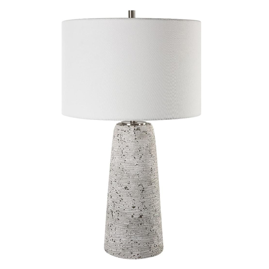 This tapered ceramic lamp has a distressed off-white finish, brushed nickel accents, and a white linen shade, adding timeless elegance to any space.