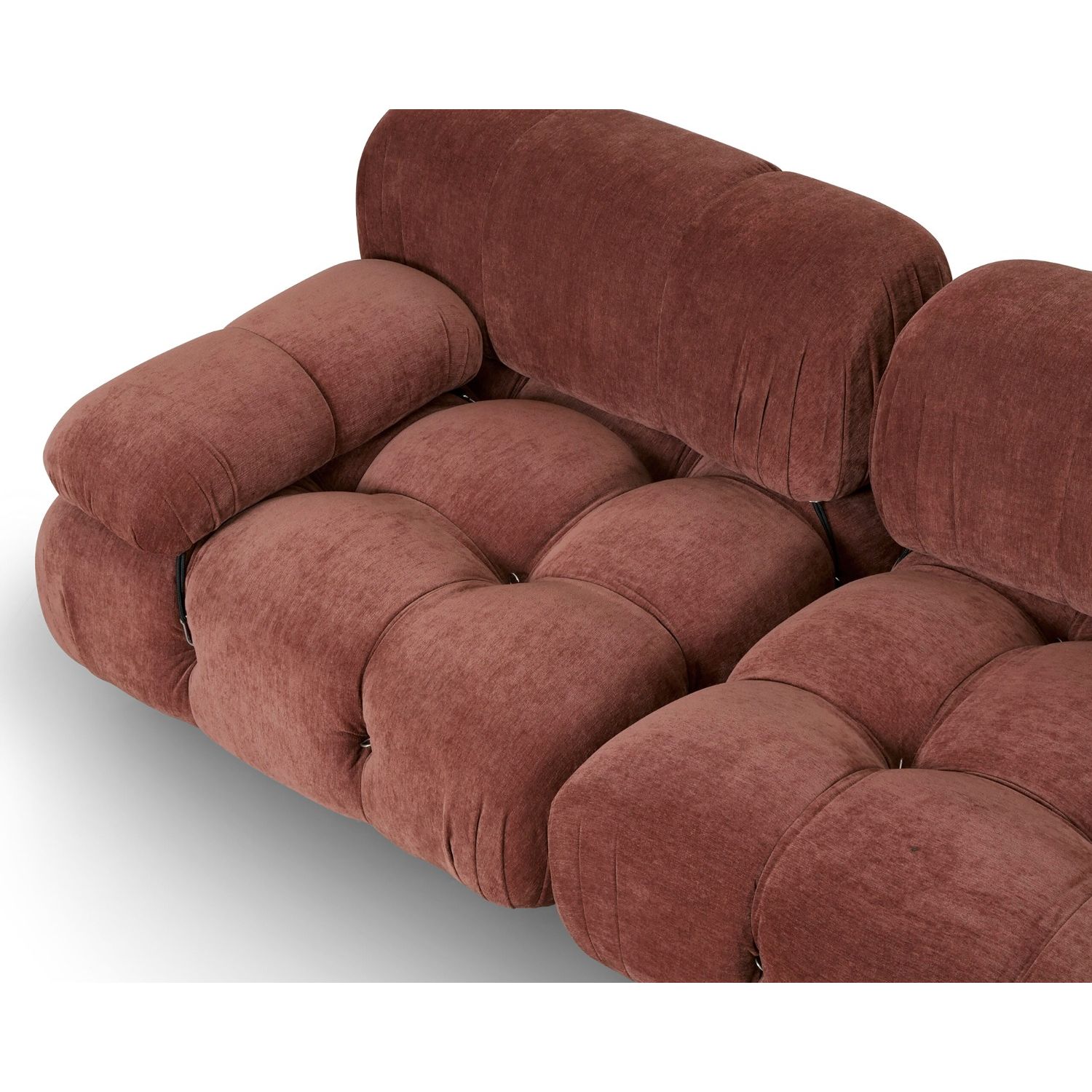 A statement modular sofa with a stylish rust upholstery and deep buttoned design