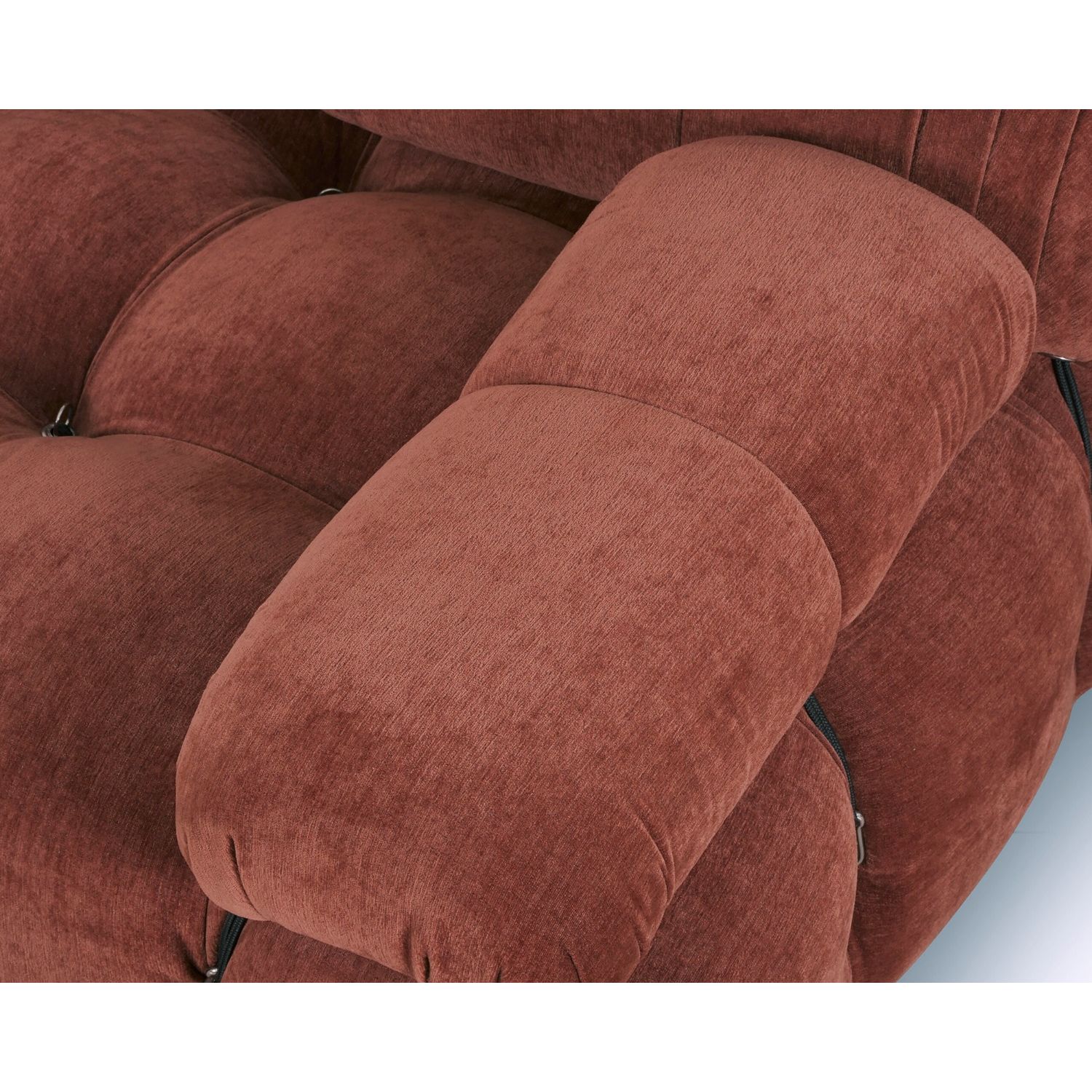 A statement modular sofa with a stylish rust upholstery and deep buttoned design