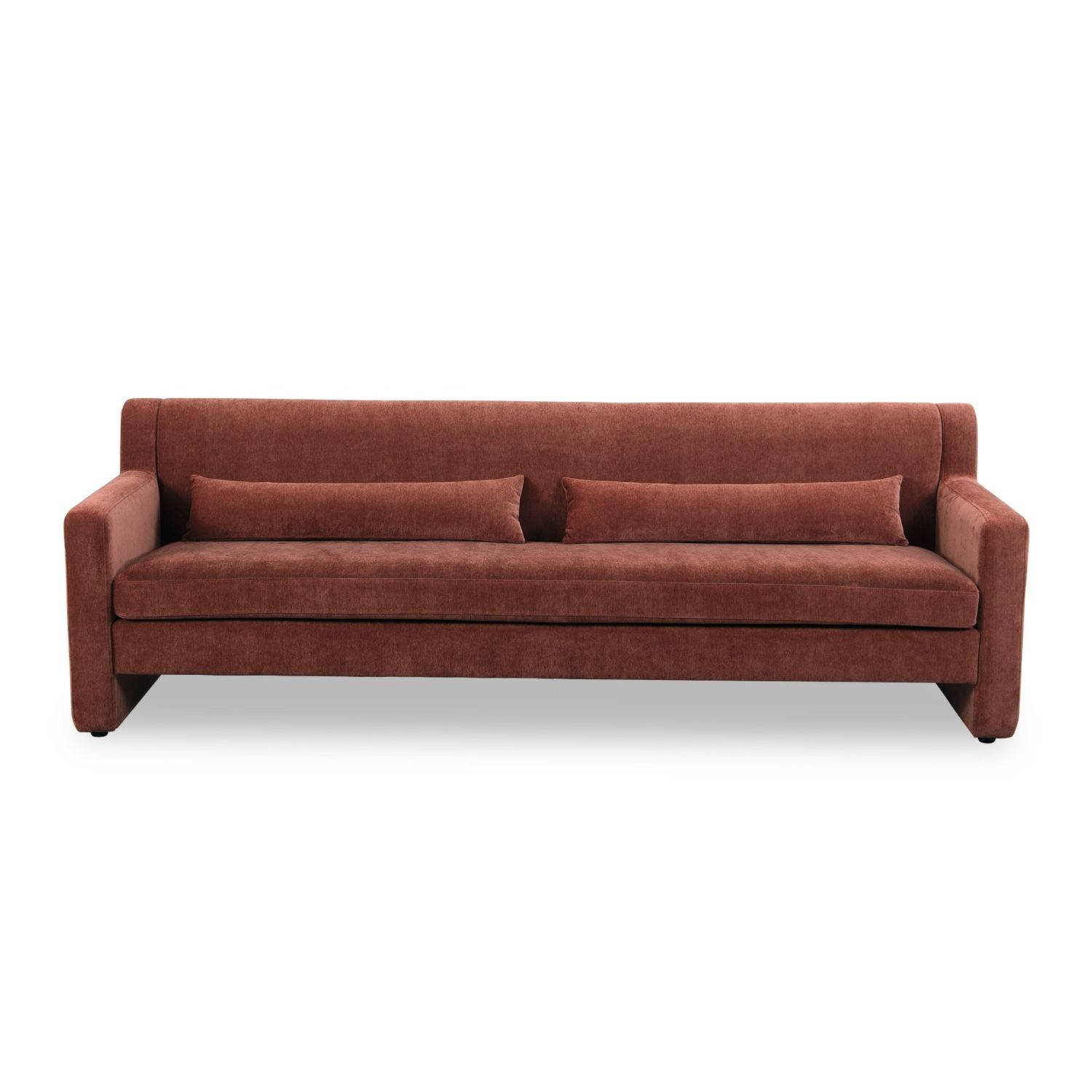 A modern sofa with a statement rust upholstery and scatter cushions