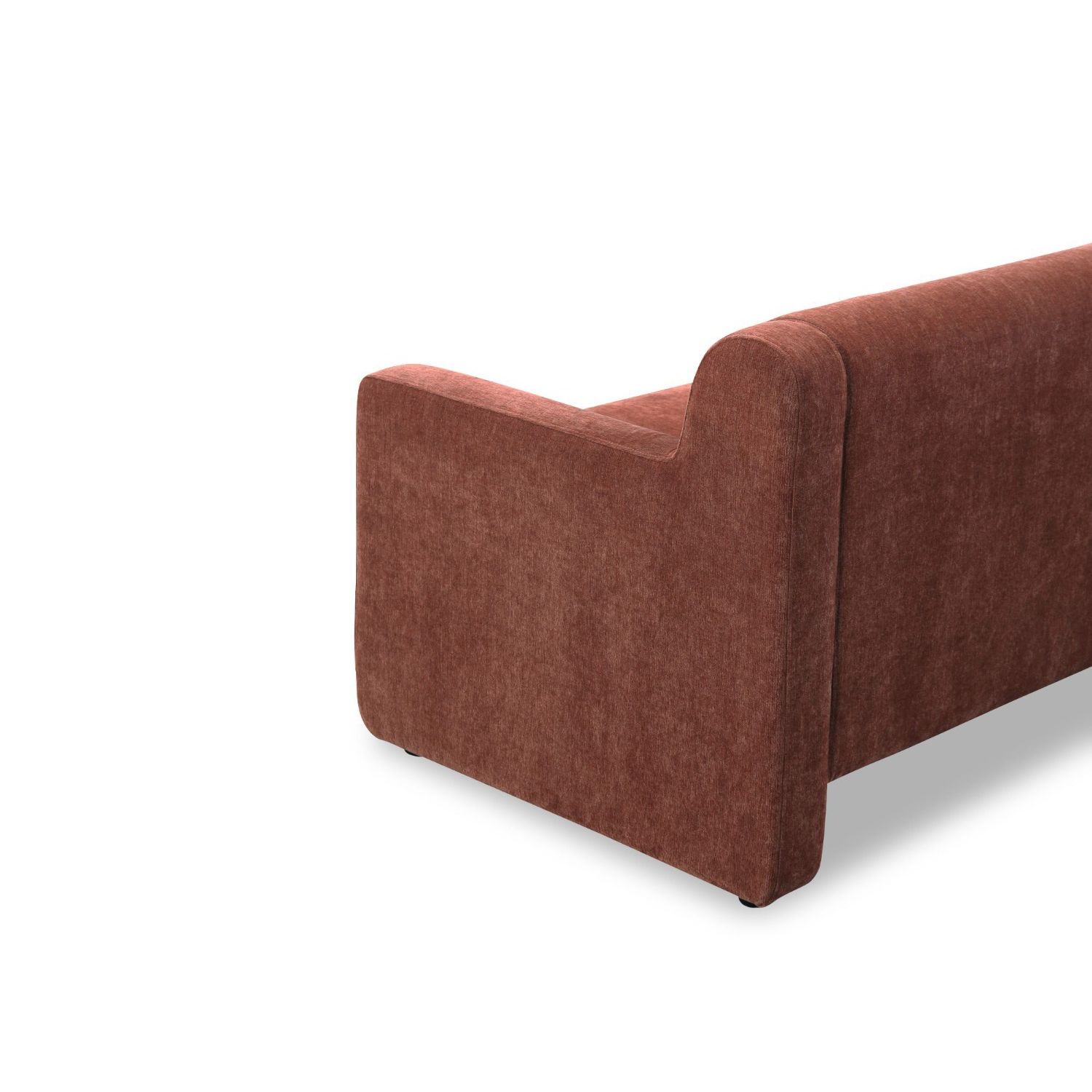A modern sofa with a statement rust upholstery and scatter cushions