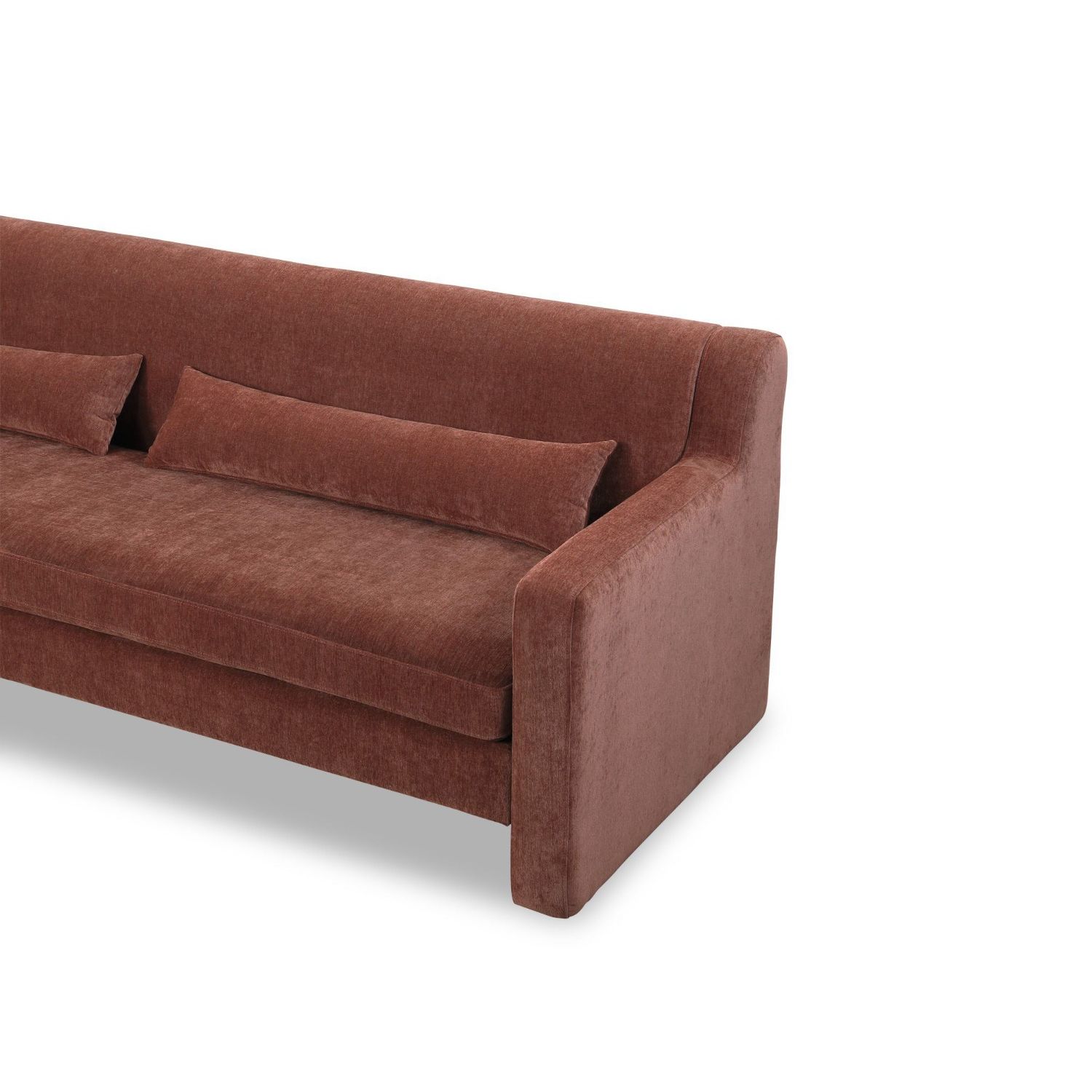 A modern sofa with a statement rust upholstery and scatter cushions