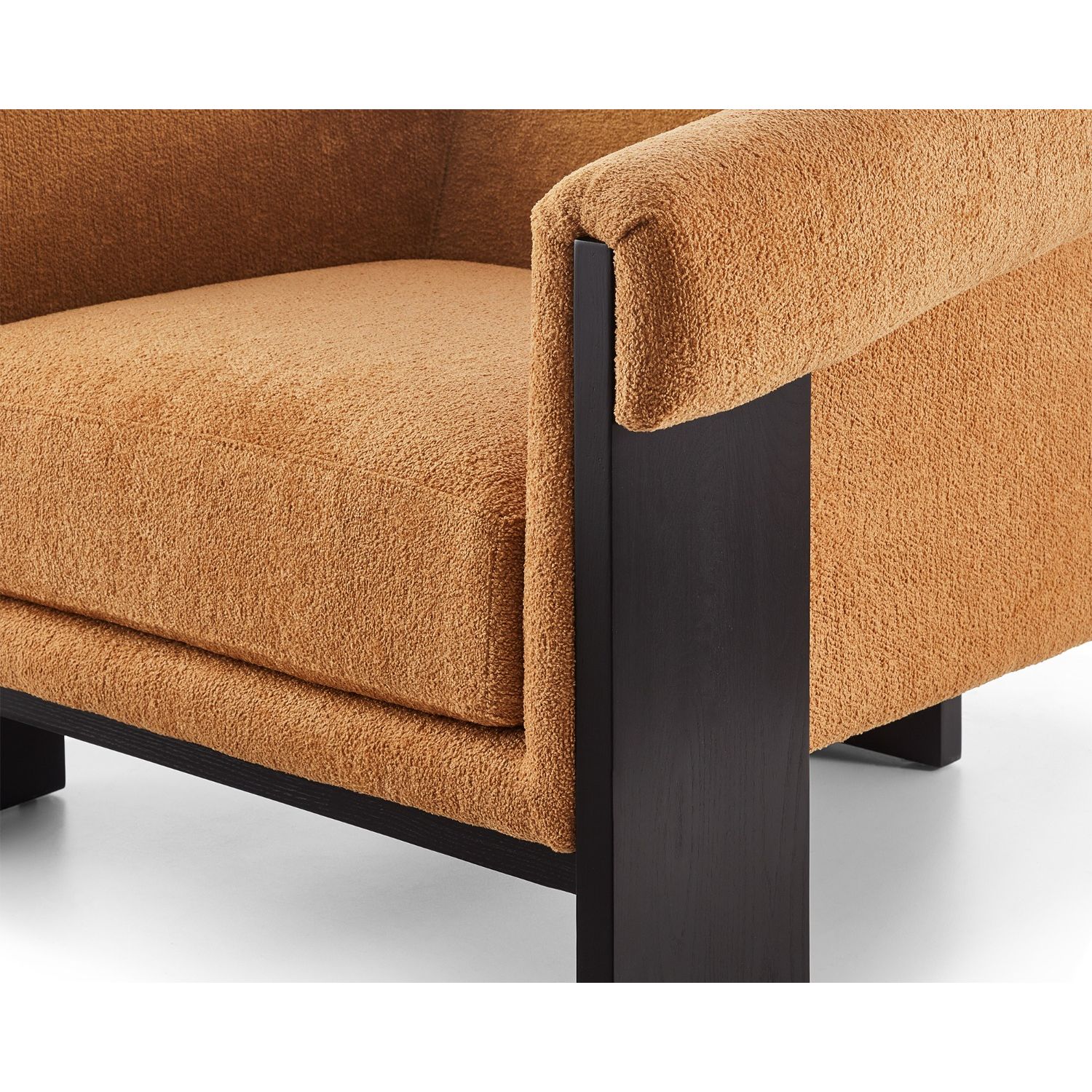 A statement armchair with a bright upholstery and black wood finish