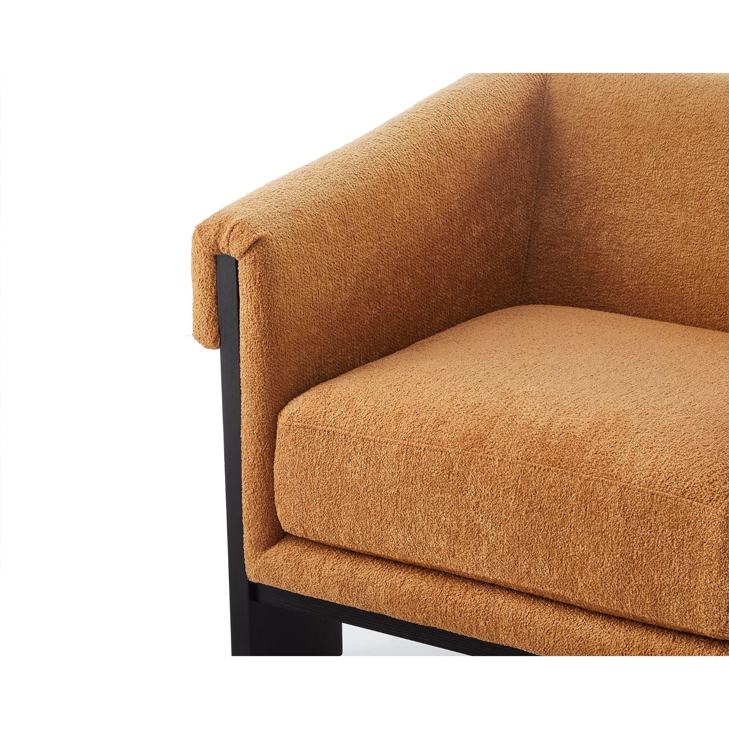 A statement armchair with a bright upholstery and black wood finish