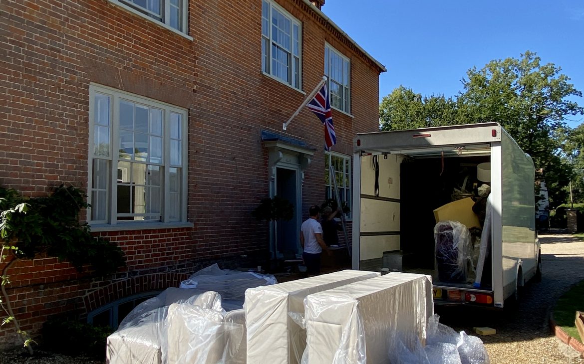 a shot of packaged furniture outside a house